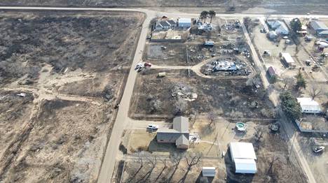 An aerial photo taken on Wednesday shows the terrain and buildings destroyed by the forest fire in the town of Stinnett.