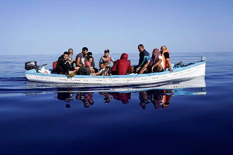 Migrants in a wooden boat on their way to the Italian island of Lampedusa on 28 August.