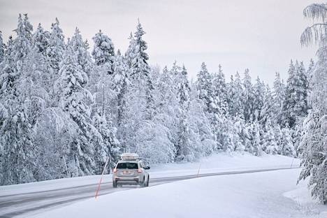Auto lumisessa maantiemaisemassa Kittilässä 19. joulukuuta 2021.