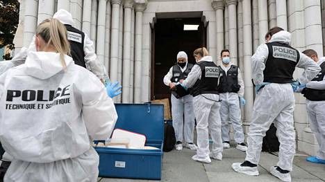 GDN; French forensics officers operate outside the Basilica of Notre-Dame de Nice after a knife attack in Nice on October 29, 2020. -