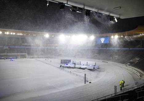 Snow sometimes hampered visibility at the Olympic Stadium before the show began.