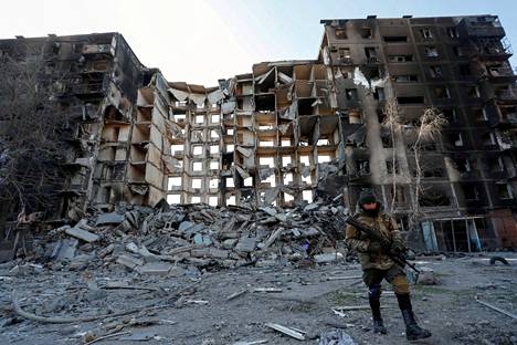 Venäläinen asemies käveli maanantaina Mariupolissa, jonka Venäjä on tuhonnut lähes kokonaan pommeilla ja tykistöllä.