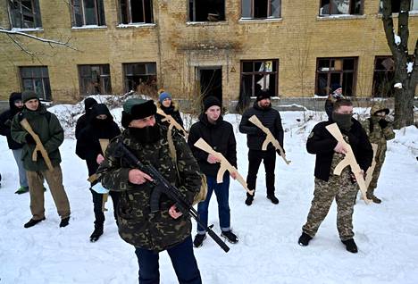 Ukrainian civilians were briefed on warfare in the capital, Kiev, on Sunday.  Civilians held wooden replicas of Kalashnikov assault rifles.