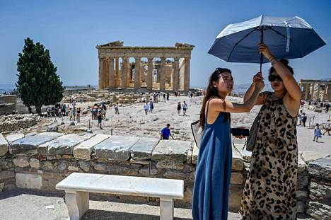 Tourists in Athens on the Acropolis hill in July 2022. Last week, the hill was closed in the afternoons for a few days due to the heat.