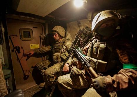 Ukrainian soldiers inside an MRAP vehicle near the Bahmut front line on May 30. 