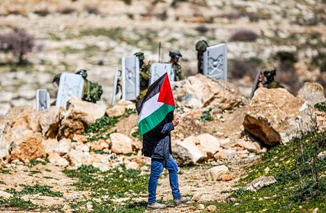 Palestiinalainen mielenosoittaja ja israelilaiset poliisit olivat vastakkain Länsirannan Nablusissa perjantaina.