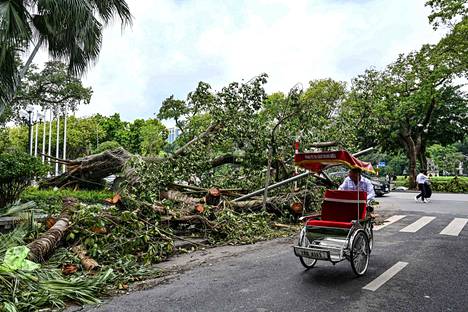 The storm has brought down trees in the capital Hanoi.