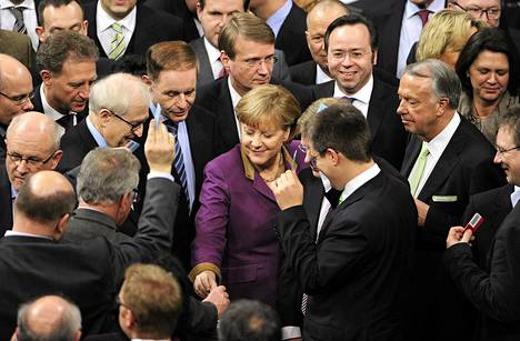 Saksan liittokansleri Angela Merkel pudottaa äänestyslippunsa parlamentissa. Saksan parlamentti hyväksyi Kreikan tukipaketin äänin 496-90. 