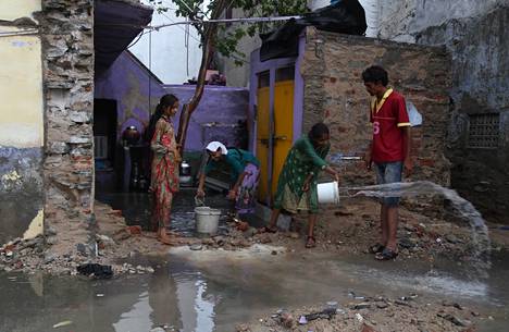 The family cleaned the water from their house in Beawar, India on June 2, 2021.