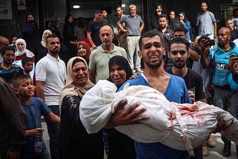 A Palestinian man carried the body of a relative killed in an Israeli airstrike in Gaza on Tuesday.