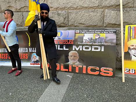 A Sikh activist collects props on Howe Street in Vancouver after a protest against Indian Prime Minister Narendra Modi.