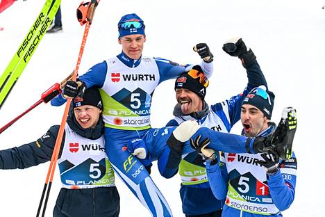 Iivo Niskanen (left), Perttu Hyvärinen and Ristomatti Hakola (right) lifted Niko Anttola to the golden chair after the anchor leg of the World Cup Relay.  Anttola brought Finland to the finish line in second place.