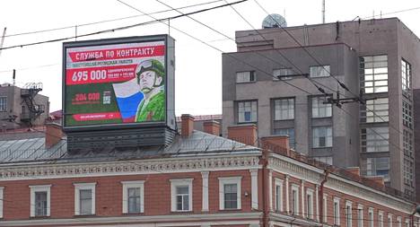 Russians were lured to fight in Ukraine with an advertisement in St. Petersburg last summer.  Behind the notice on the right is the headquarters of the intelligence service FSB.  The advertisement promises a sum of about 7,000 euros for signing the contract and a monthly salary of about 2,000 euros.