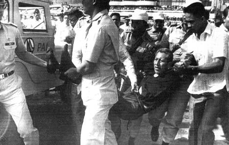 Turvallisuuspoliisit kantavat pois paavin murhaa yrittänyttä bolivialaista Benjamin Mendozaa. Paavin lähellä olleet pappismiehet ja Filippiinien presidentti Ferdinand Marcos estivät Mendozaa iskemästä veistään paaviin.