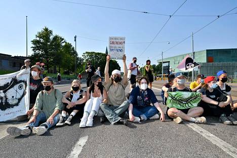 Elokapinan osallistujat vaativat toimia ilmastonmuutosta vastaan mielenosoituksessaan kesäkuussa 2021. He istuivat ajoradalla Mannerheimintiellä Eduskuntatalon kohdalla.