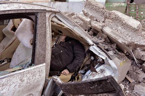 Dead woman inside a crushed car in Kharkov on Sunday.