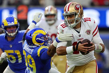 Los Angeles Rams ’Aaron Donald (left) sacked San Francisco 49ers quarterback Jimmy Garoppolo as the teams faced off in the regular season final on Jan. 9.