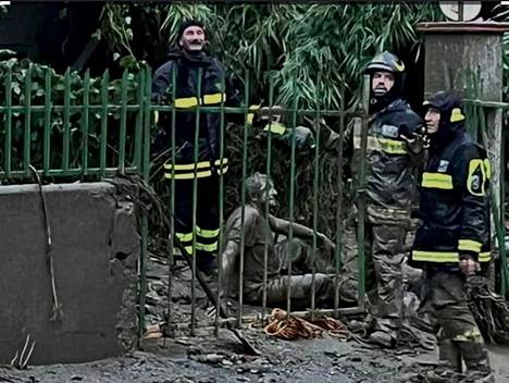 Rescue workers helped a man stuck in the mud.