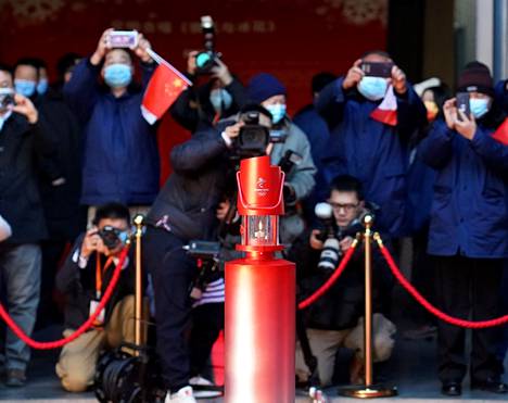 Kasvomaskeilla varustetut kuvaajat ikuistivat Pekingissä esillä olleen olympiatulen joulukuun 13. päivänä.