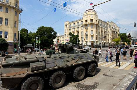 People walking past an armored vehicle in Rostov-on-Don.