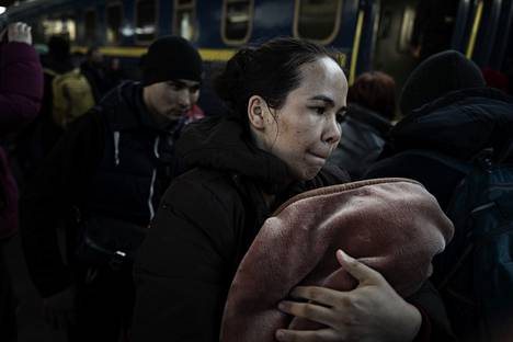 The woman left Kiev railway station.  There are a lot of aspirants to the trains, and not everyone can fit in at once.