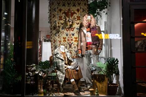 Decorating a smaller store window often starts with a piece of furniture or textile. 