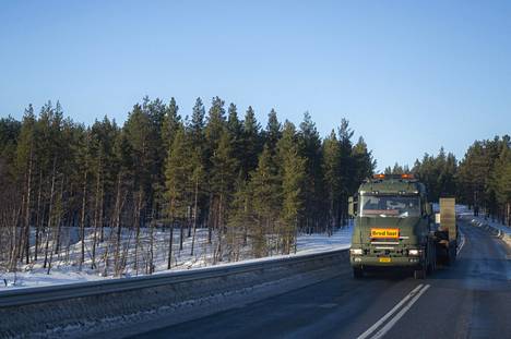 The wide transport van of the Defense Forces drove south on highway 21.