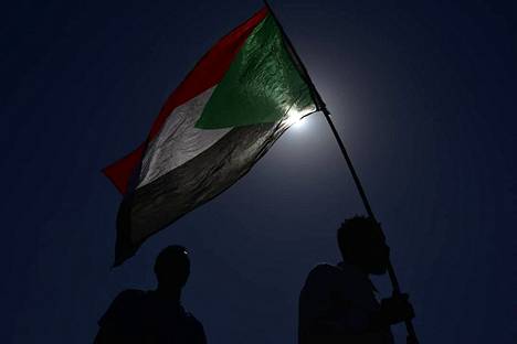 Ihmiset kantoivat Sudanin lippua sotilasvallankaappausta vastustavissa mielenosoituksissa pääkaupunki Khartumissa lauantaina.