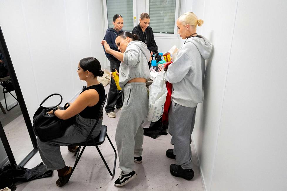 Abreu and the dancers prepare for the gig in a container that doubles as a bakery.