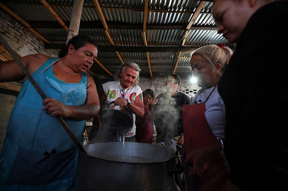 Volunteers cook a pot meal at a food aid center in the Villa Fiorito district of Buenos Aires on February 13.