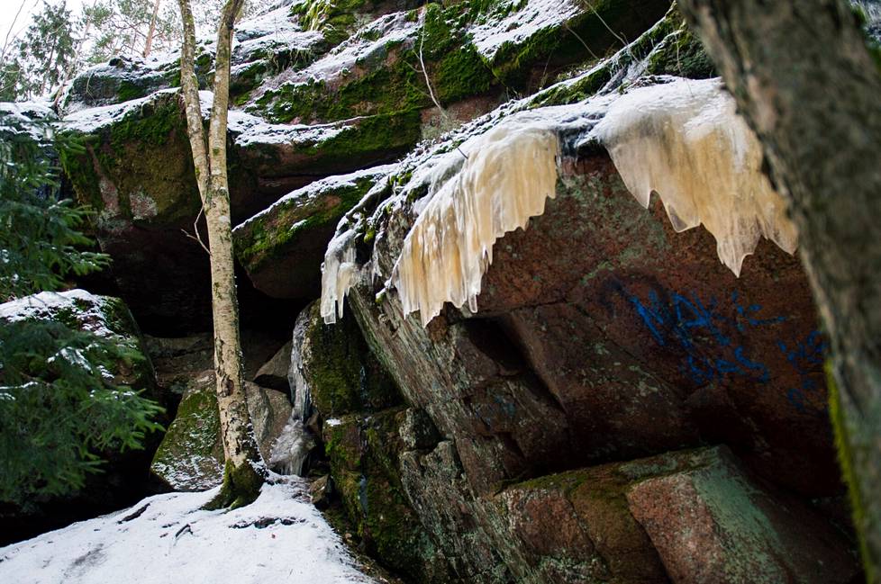 Ancient rocks have been smeared with graffiti and rubbish.