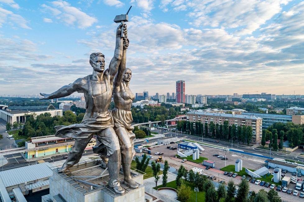 Työläismies ja kolhoosinainen pitelevät sirppiä ja vasaraa patsaassa, joka kurottaa kohti taivasta Kansantalouden saavutusten näyttely -puiston sisäänkäynnillä Moskovassa.