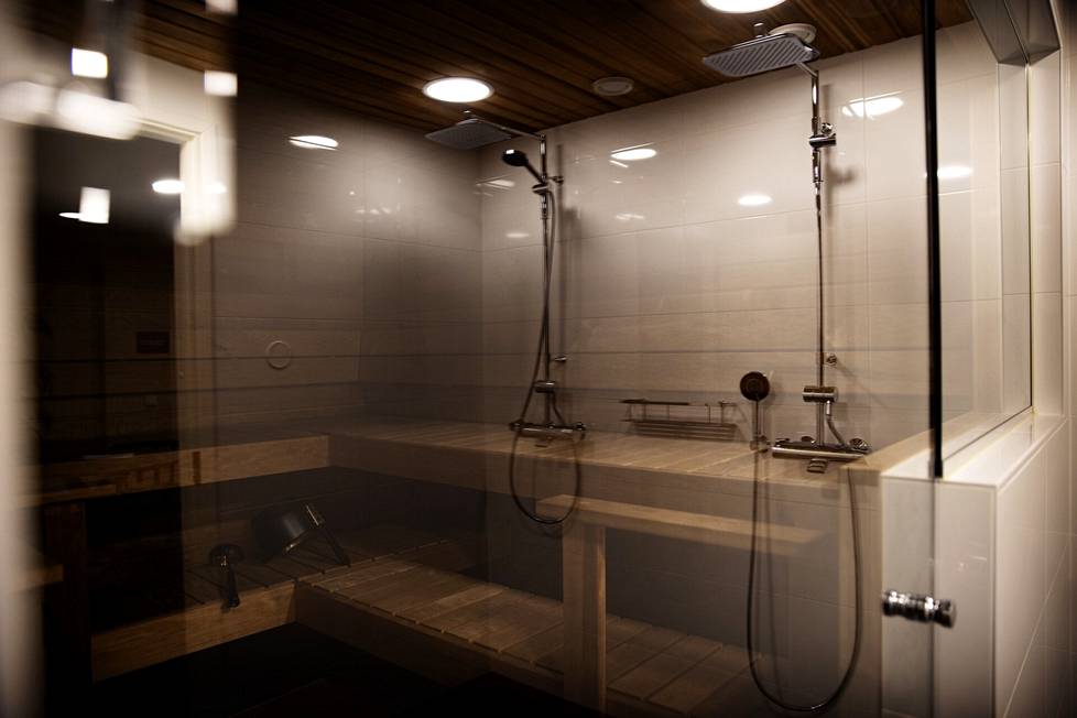 The steam room of the house sauna is remarkably large.  The showers in the washroom are reflected in the glass wall of the steam room and look like they are in the steam room in the photo.