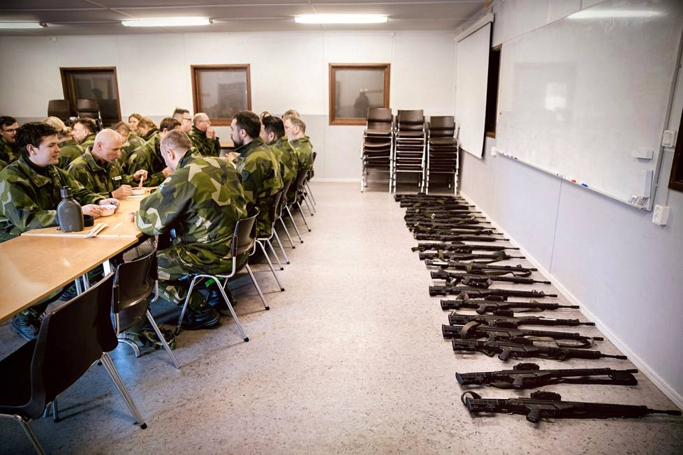Hemvärnetin harjoitukseen osallistuvat sotilaat nauttivat lounaaksi kermaista pyttipannua punajuurella. Jokaisen henkilökohtainen ase jäi odottamaan ruokailutilan reunalle.