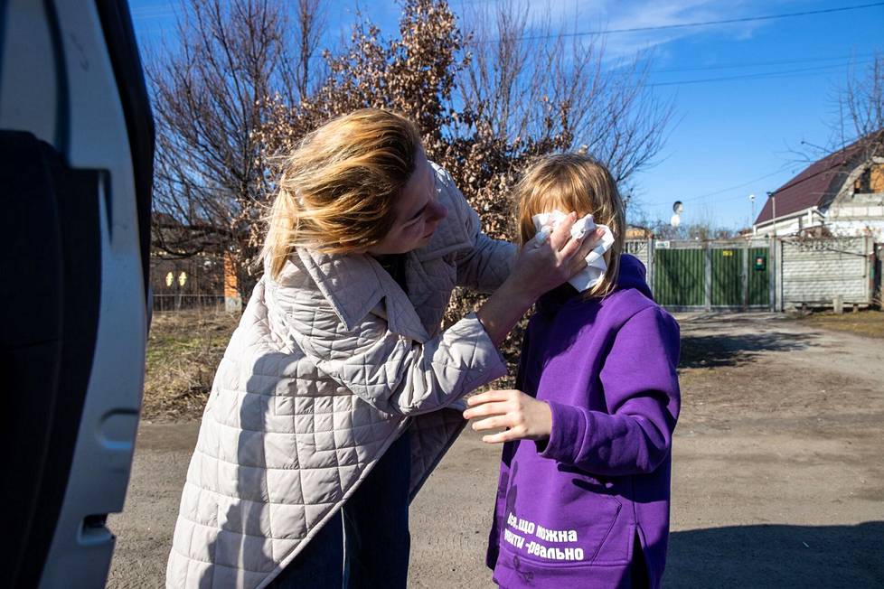 Жанна Пастушенко вытирает рвоту с лица Фроси возле Белой Церкви. Девочку вырвало в машине после того, как она съела печенье и попила воды.