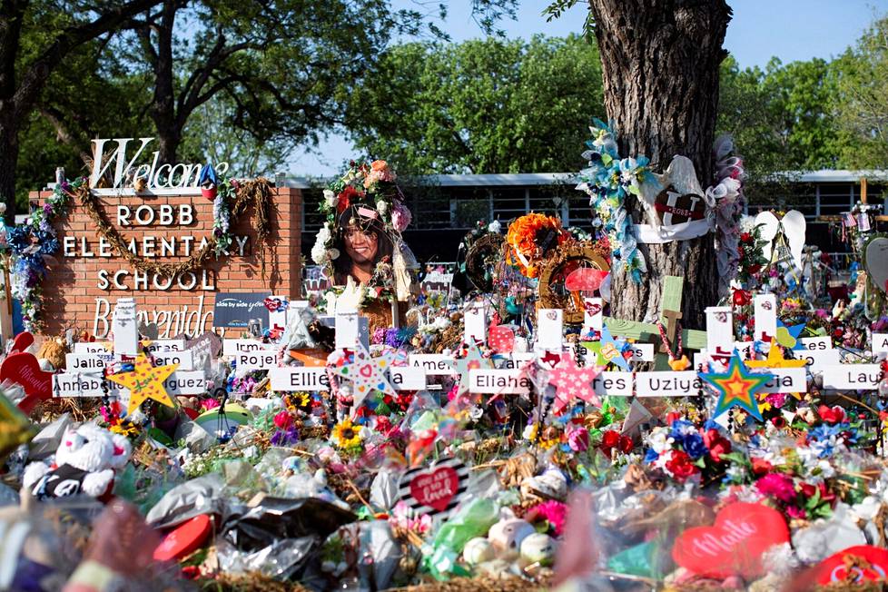 Flowers brought in memory of the victims of Robb's elementary school in Uvalde, Texas, where an 18-year-old gunman killed 19 children and two teachers in the summer.