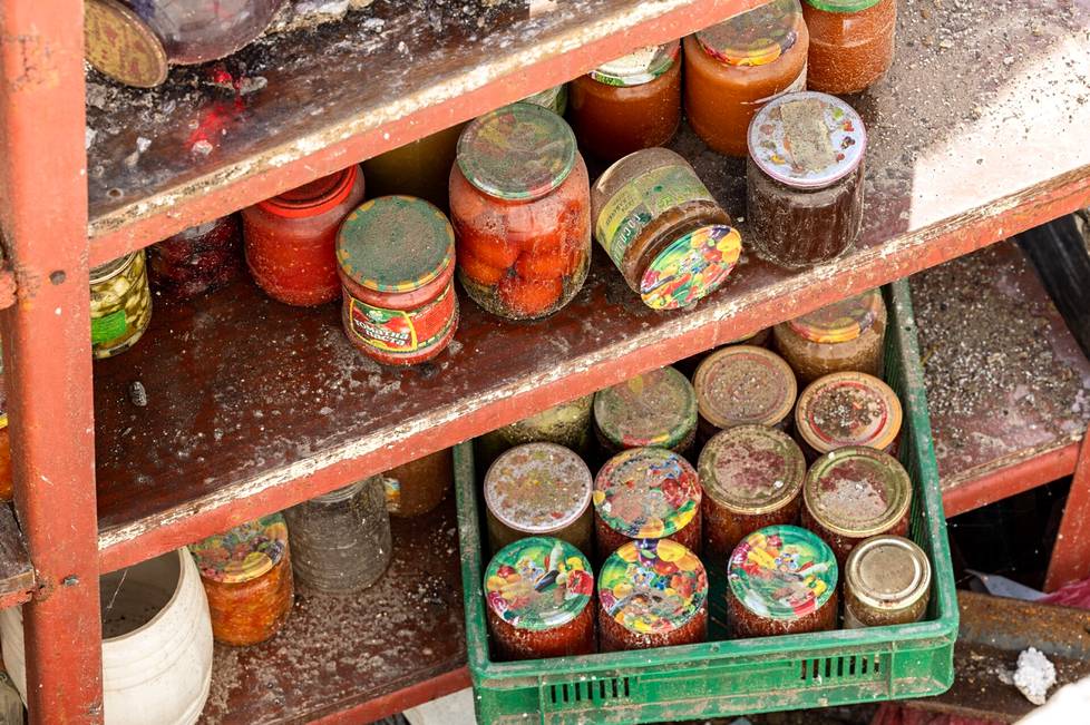 The cellar and the canned goods on its shelves were left behind when the outbuilding on top was wiped out in a missile strike. 