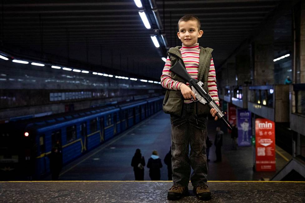 Lapsi leikkiaseensa kanssa Kiovan metroasemalla.