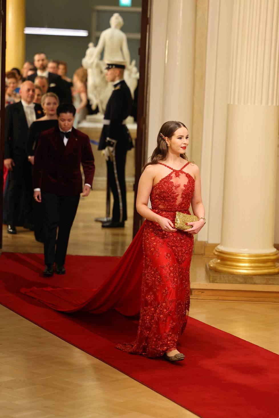 MP Elisa Gebhardi (sd)'s suit had a long red skirt.  In the background is his wife Bettiina Heino.