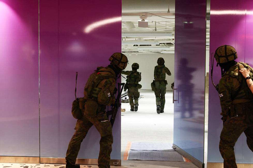 Military police inspect empty business premises.