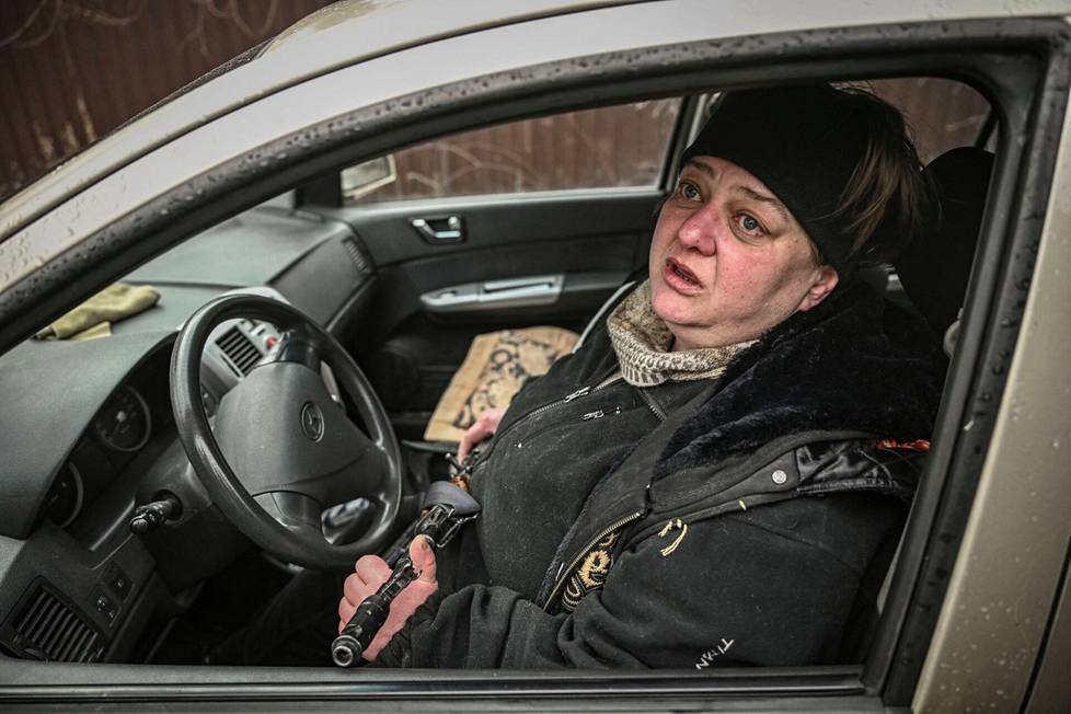 Oksana Surionova, 52, sat in a car with a gun in the village of Stojanka near Kiev on Friday.