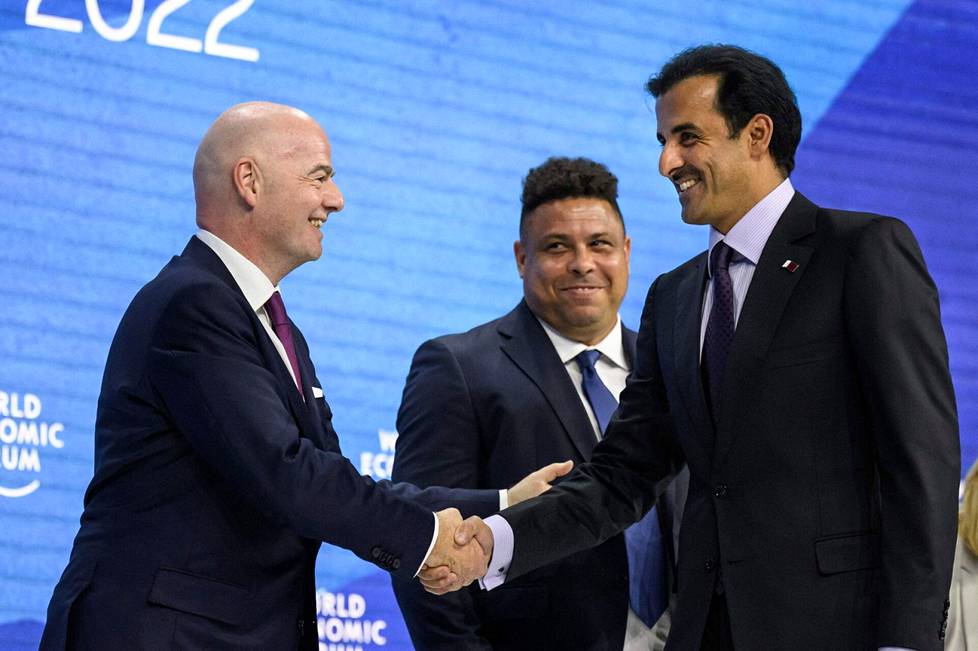 Jalkapallolegenda Ronaldo seurasi taustalla, kun Fifan puheenjohtaja Gianni Infantino (vas.) ja Qatarin emiiri Tamim bin Hamad al-Thani kättelivät Davosissa World Economic Forum -tapahtumassa toukokuussa 2022.