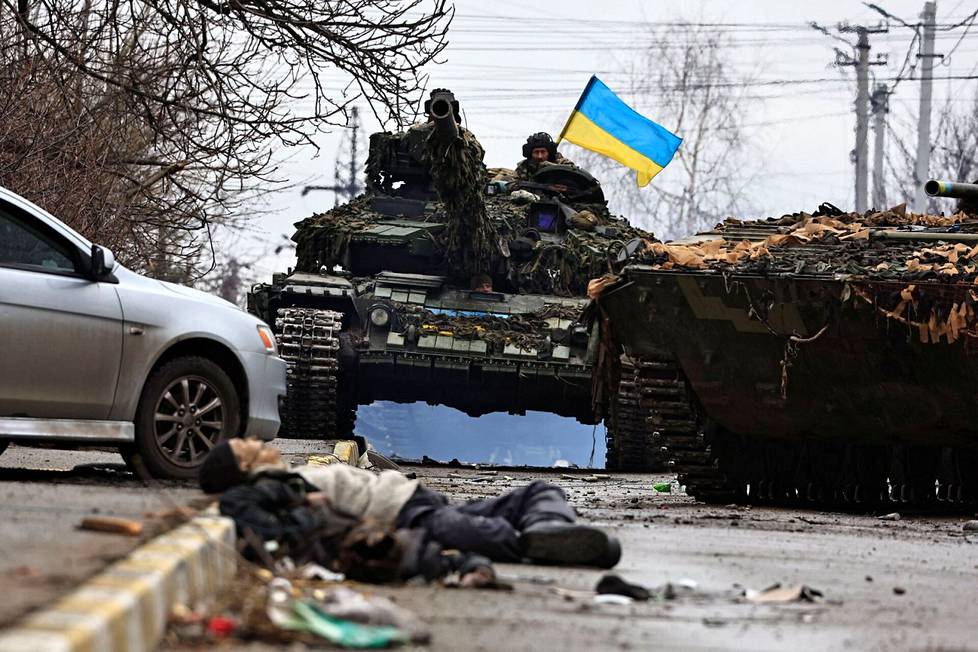 Ukrainan armeijan panssarivaunu ja kuollut siviili Butšassa lauantaina.