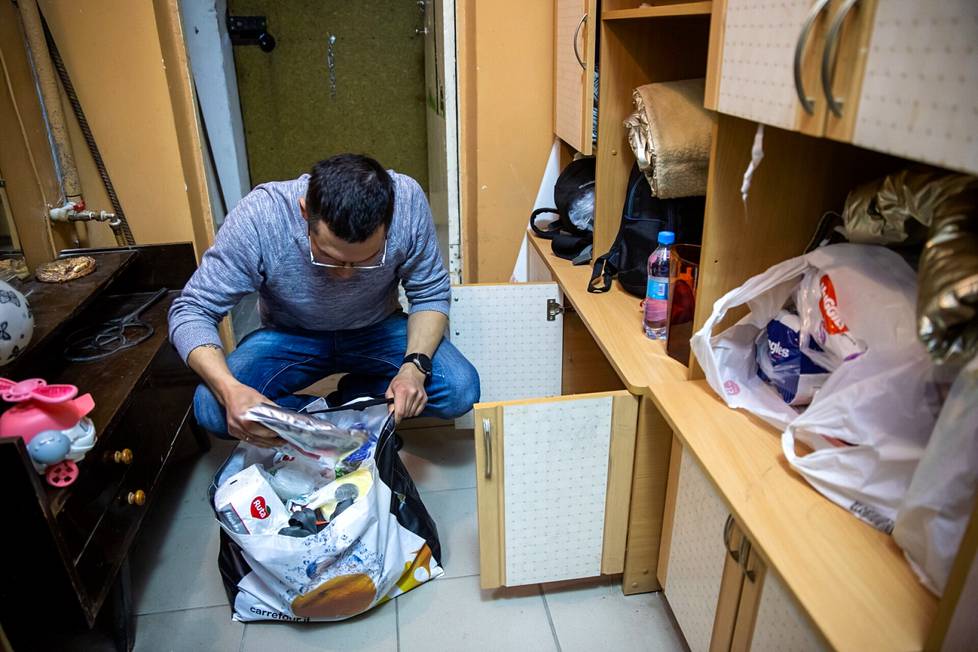 Vladimir Demchenko checks what food is pre-packed in a plastic bag in case the family suddenly has to leave home.