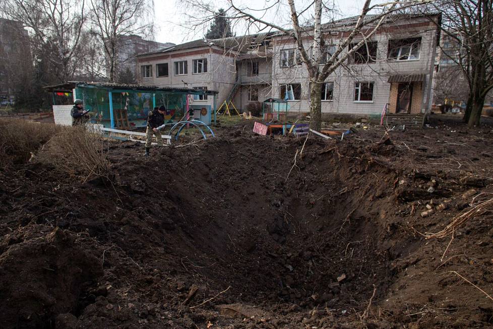 Ukrainalaiset poliisit tutkivat perjantaina kraateria, jonka Venäjän ohjusisku aiheutti Donetskin alueen Kramatorskissa päiväkodin pihalle.