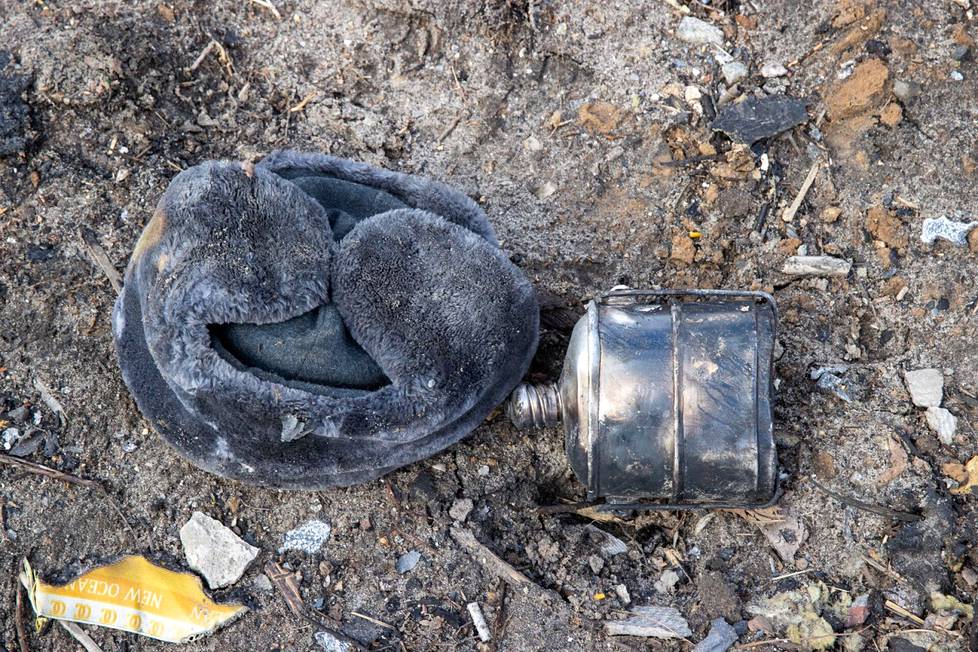 A Russian soldier's fur hat and a drinking bottle have been left on the ground.