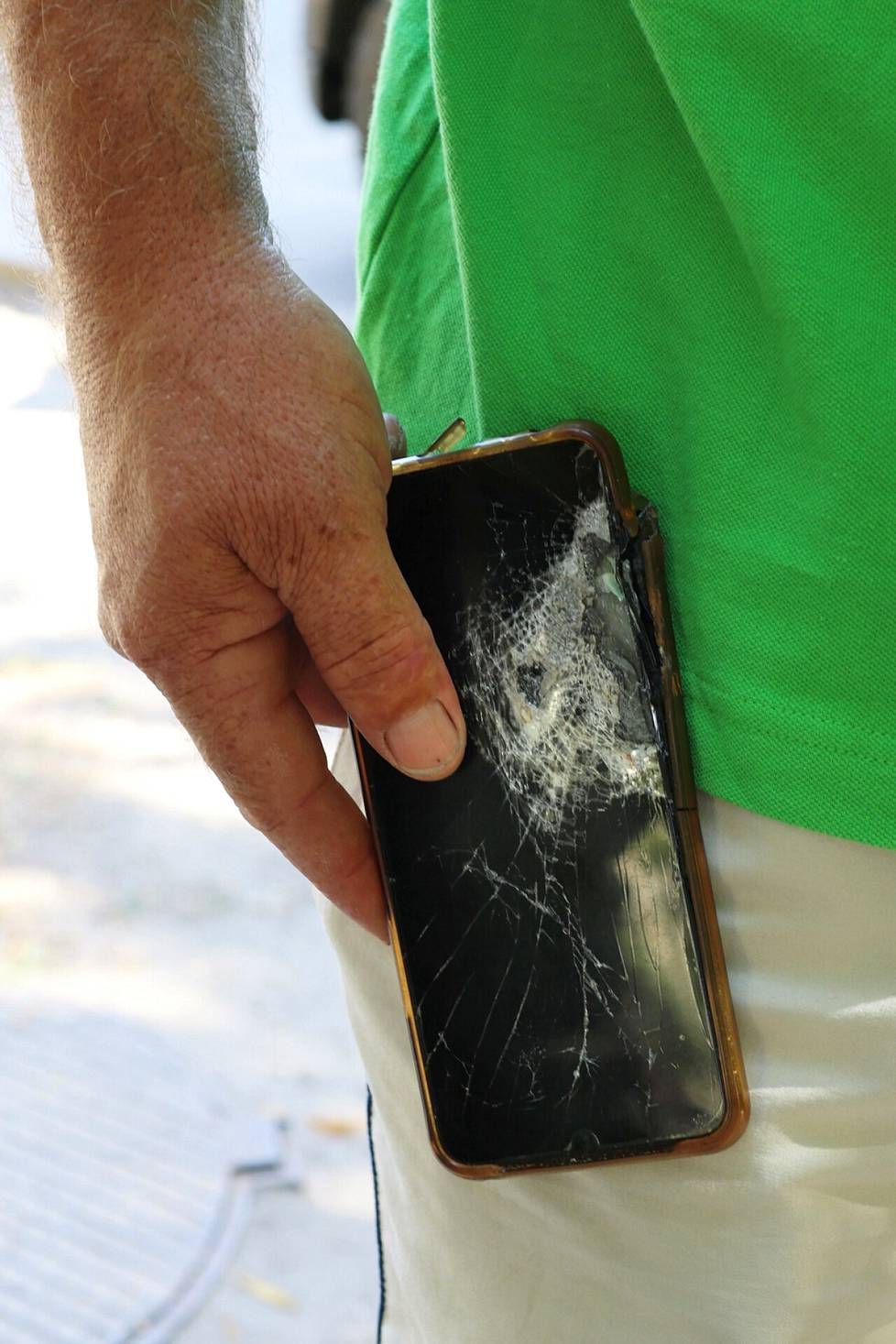 The shrapnel hit the cell phone in Serhii Ohrimenko's pocket.