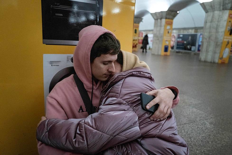 Kievans Bogdan, 24, and Helen, 23, sheltered from the metro station.